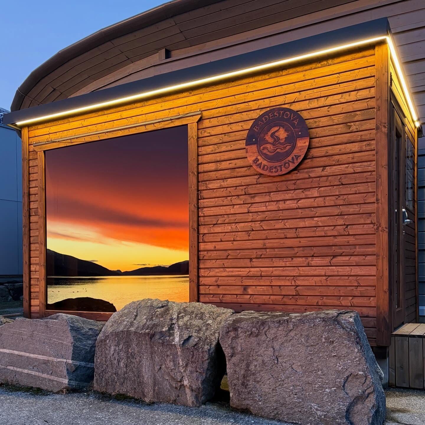 The Badestova sauna on the waterfront in Nordfjordeid at sunset