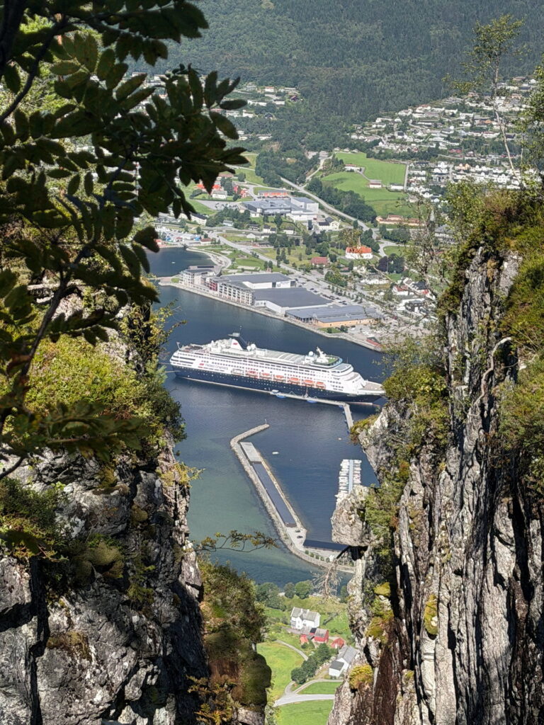 A cruise ship at the Nordfjordeid pier, seen from the ridge above Skipenes