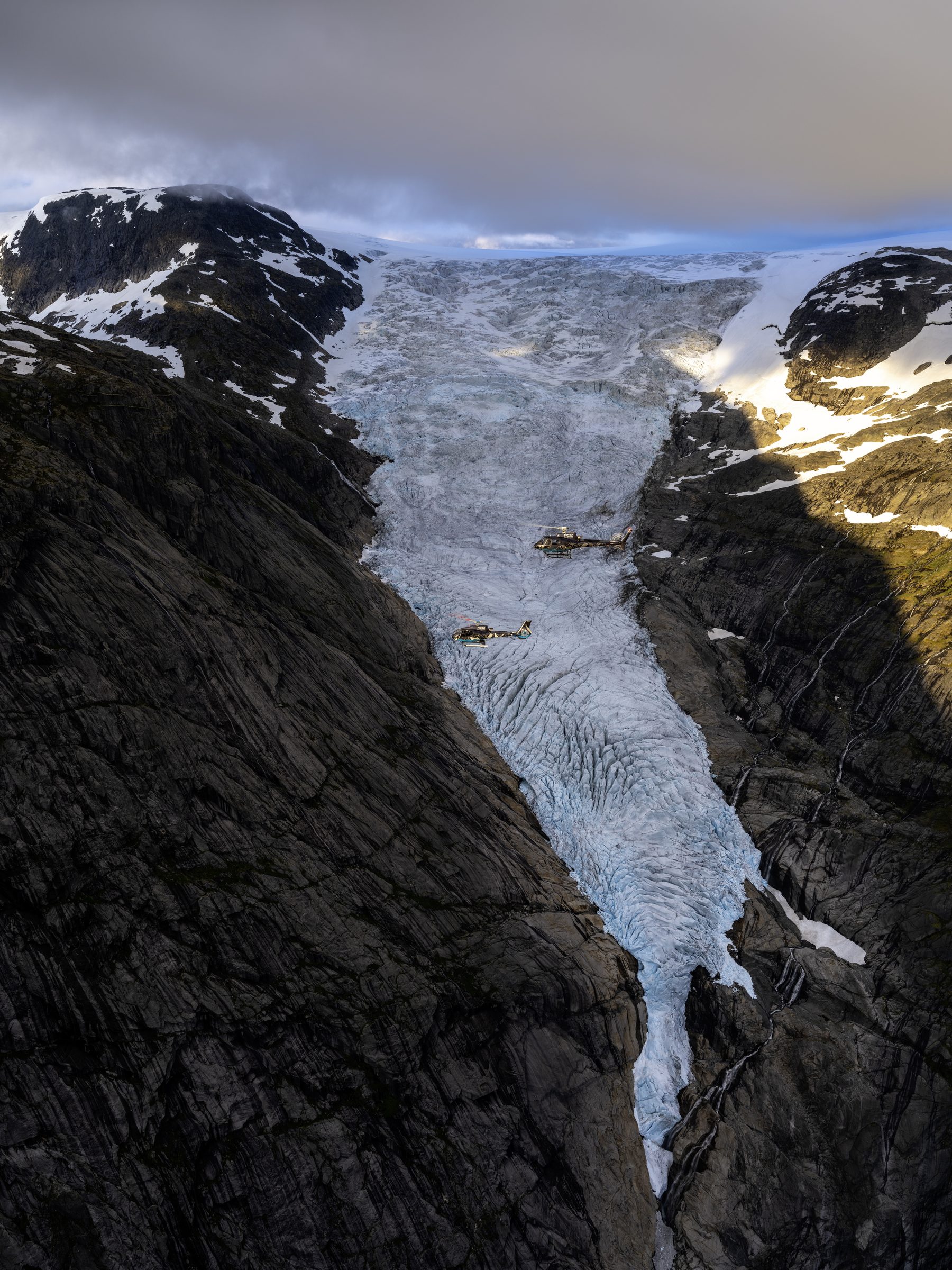 Two helicopters above Briksdalsbreen glacier.