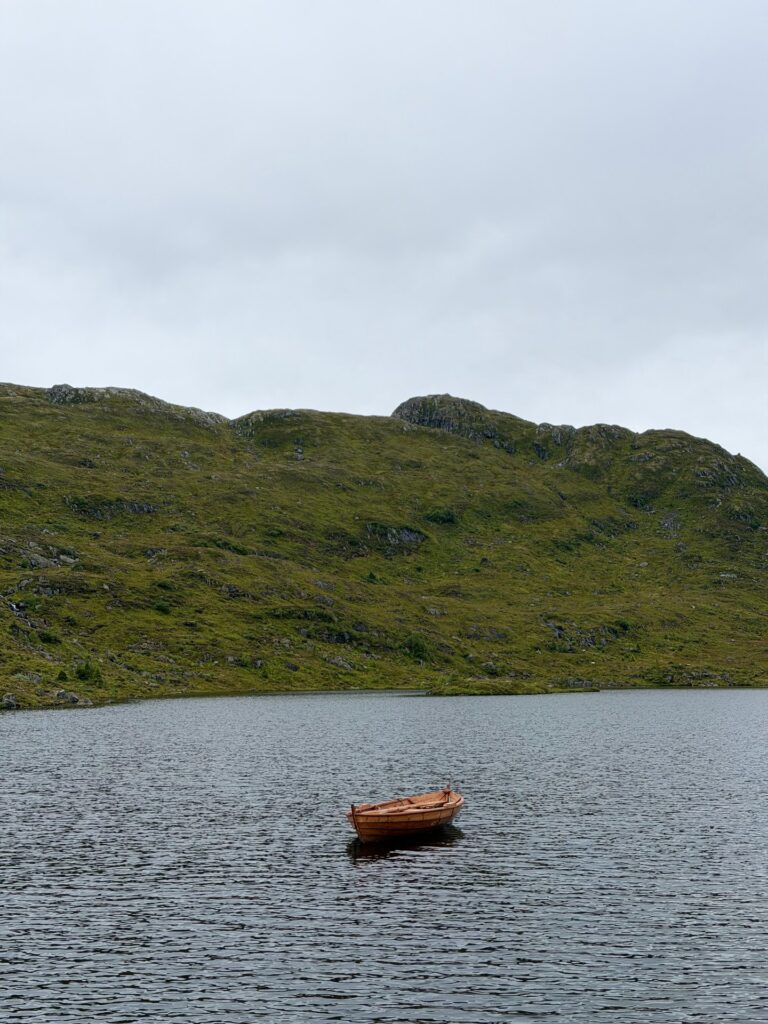 A red rowing boat on Fossevatnet, a mountain lake above Nordfjordeid