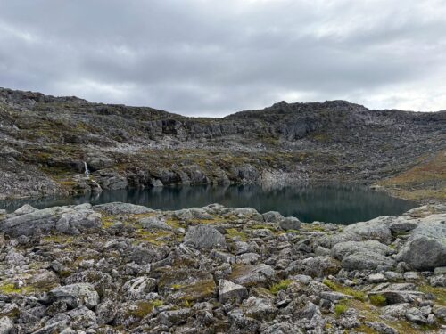 The lake Skålavatnet among rocky slopes on the way up Skåla.